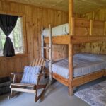 a bunk bed in a room with a rocking chair