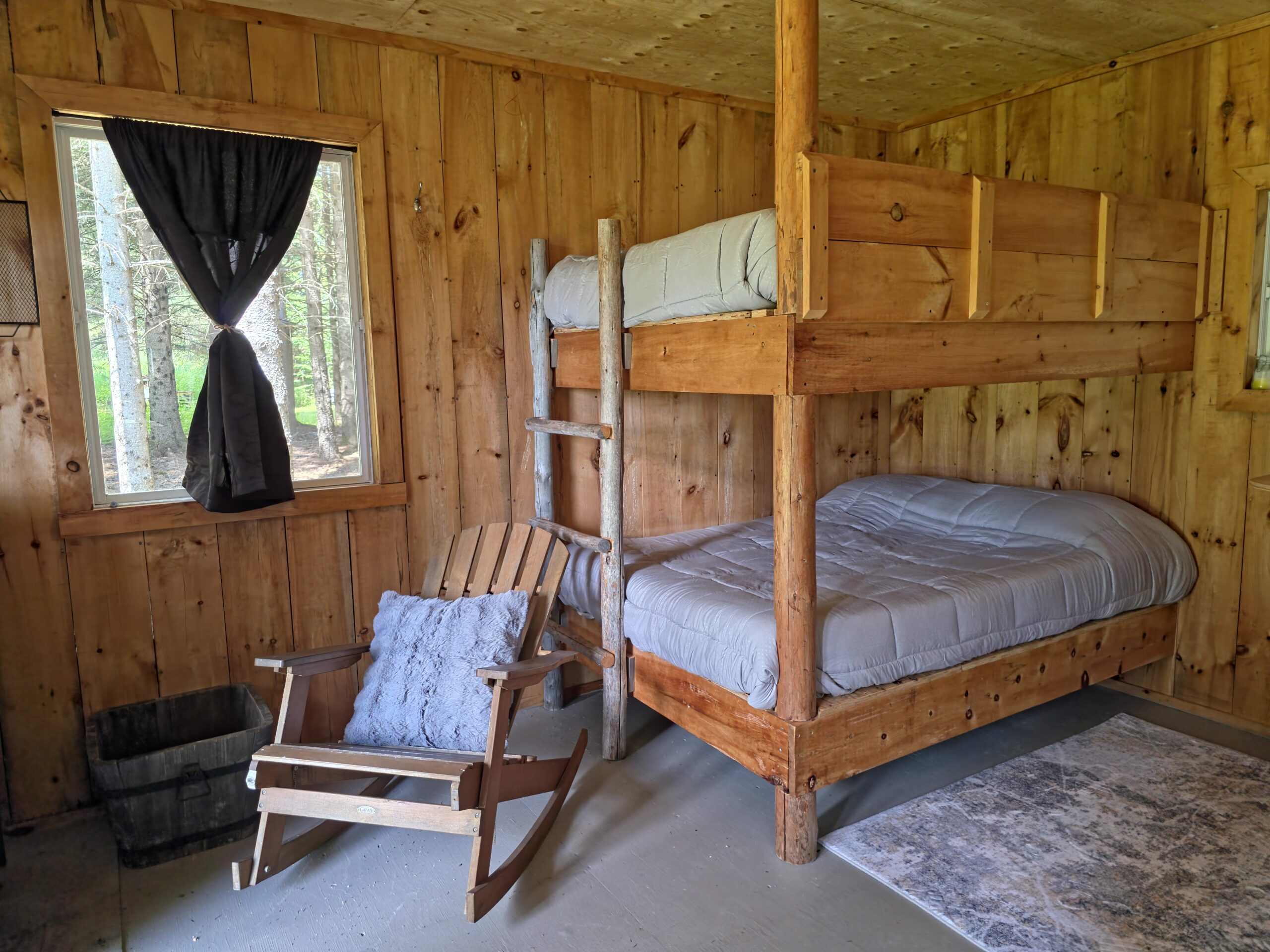 a bunk bed in a room with a rocking chair